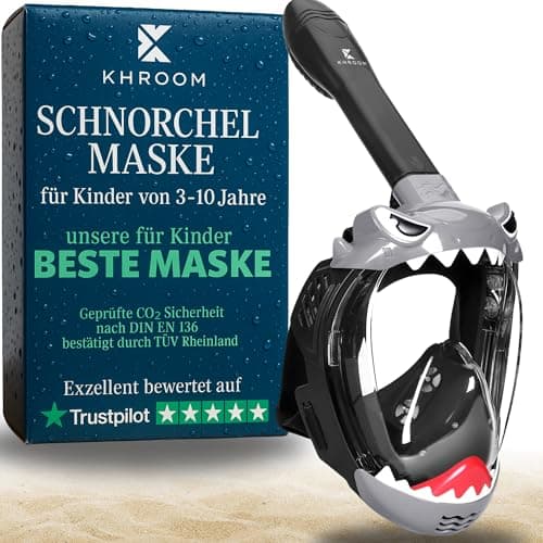 Khroom Kinder-Schnorchelmaske im Hai-Design neben blauer Verpackung auf Sand